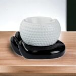 Hand Holding a Golf Ball Style Ceramic Ashtray